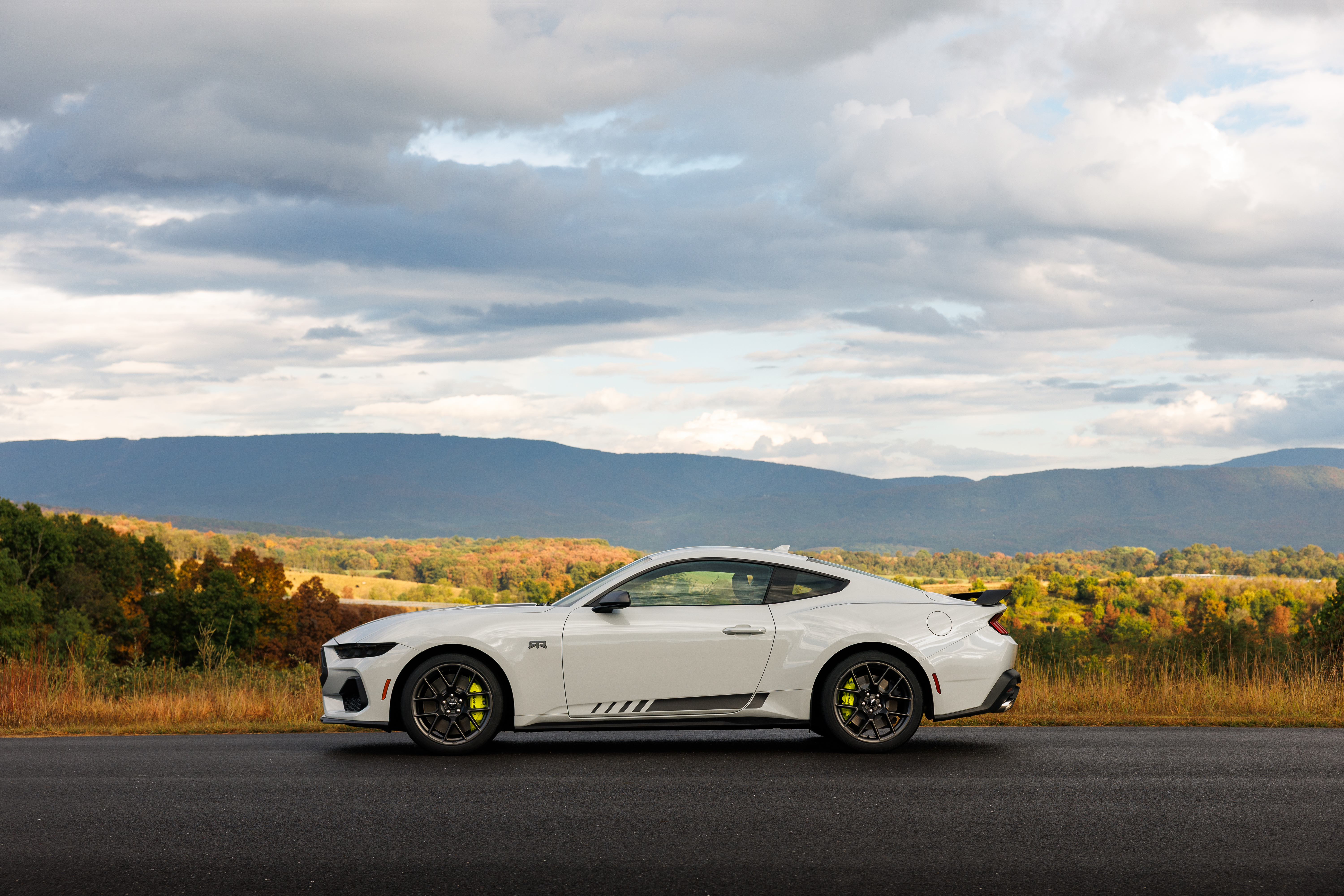 Optional RTR package available on 2026 Ford Mustang EcoBoost fastback. Preproduction model shown with optional Hyper Lime brake caliper shown. Available late spring 2026.